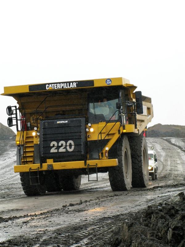 Huge Caterpillar truck being supported by one of the Miller Argent Land Rover Defenders (fitted with SuperPro bushes)